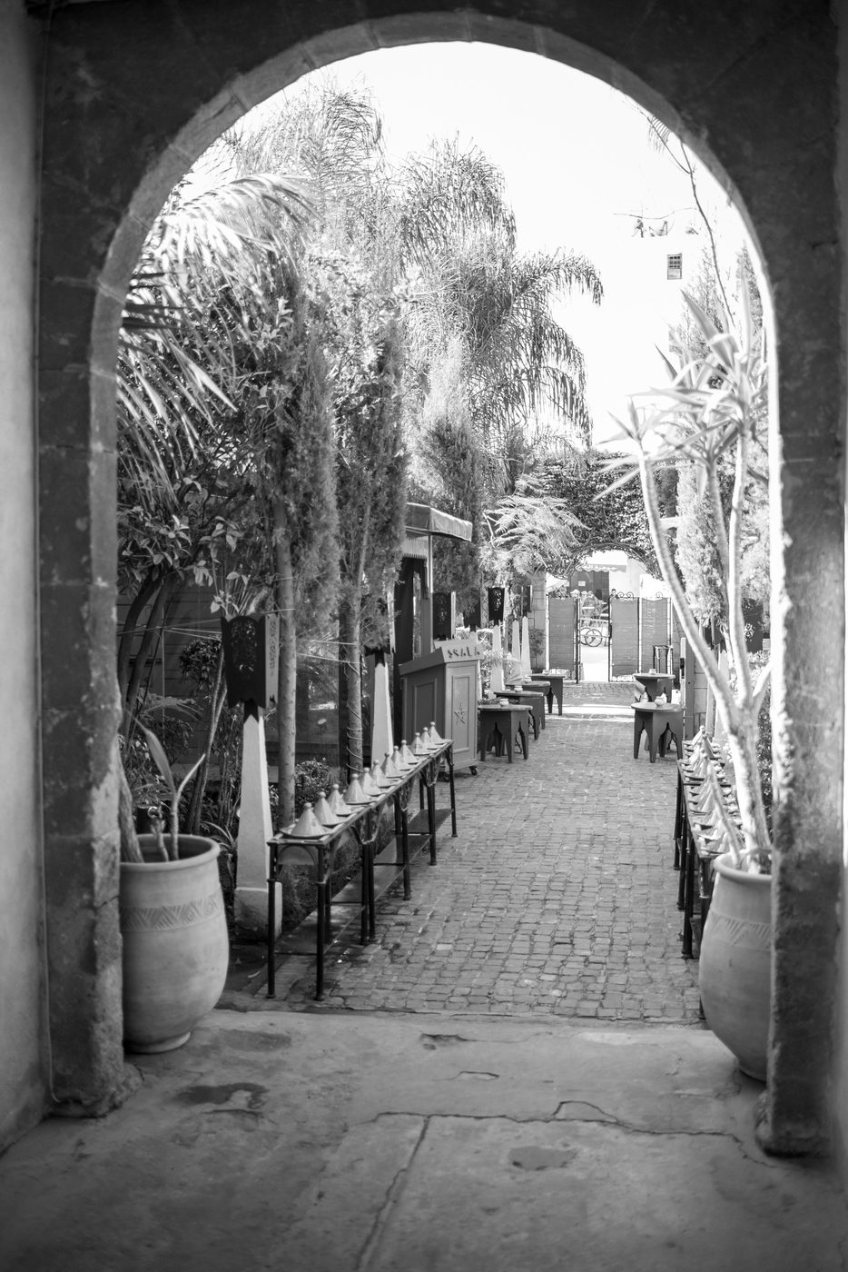 Courtyard lined with tagine-shaped lamps seen through an arch, Casablanca