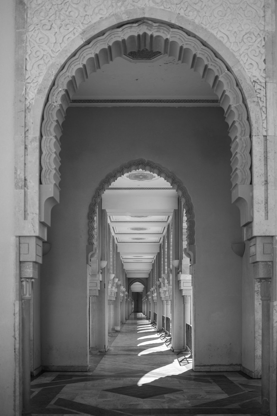 Row of carved arches lit by the low raking light, Casablanca