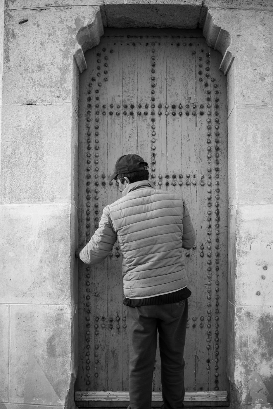 Man facing a heavy old studded door, Casablanca