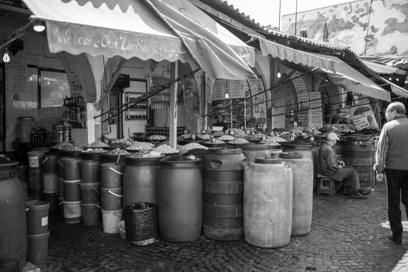 Barrels of olives lined up under the market's awnings, Casablanca