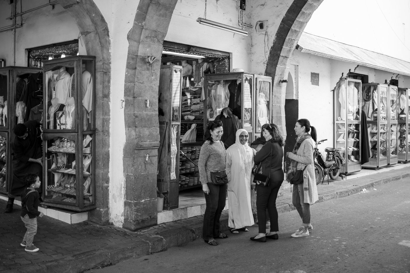 Women laughing together in front of a shop under the arcade, Casablanca