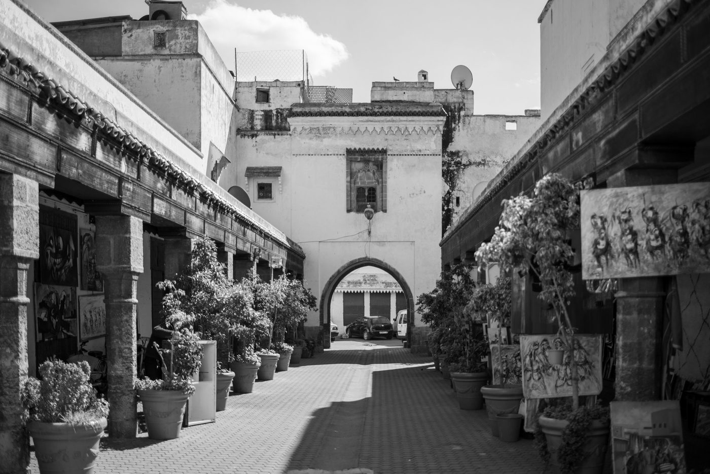 Open-air art gallery leading toward an old arch, Casablanca