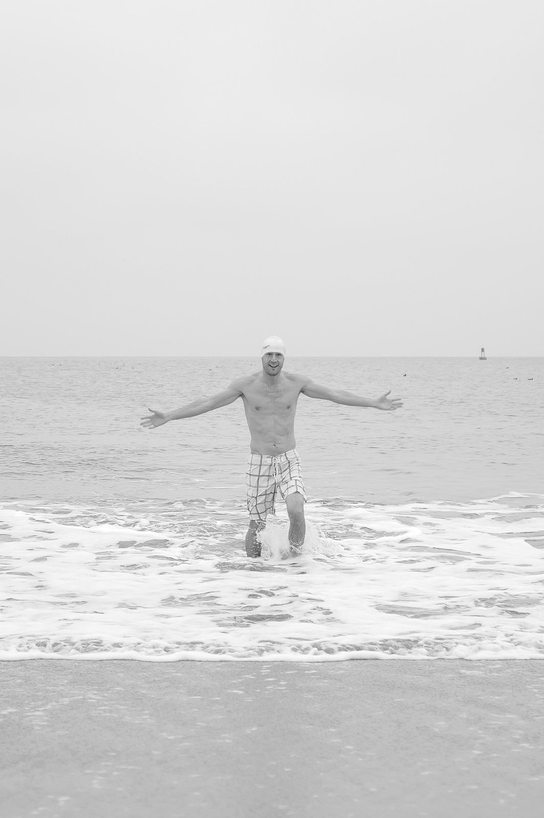 Silhouette of a man with arms spread in the ocean, Coney Island