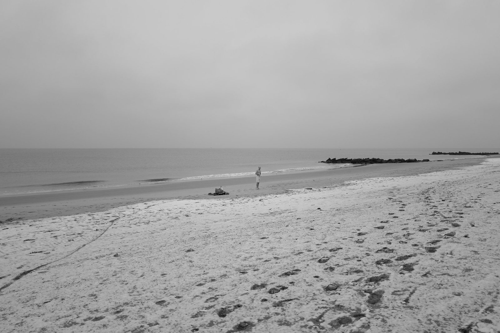 Lone walker on an empty beach, Coney Island
