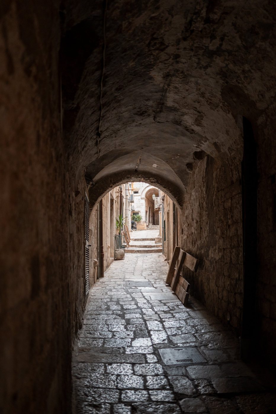 Dark vaulted passage leading to a sunlit alley, Dubrovnik