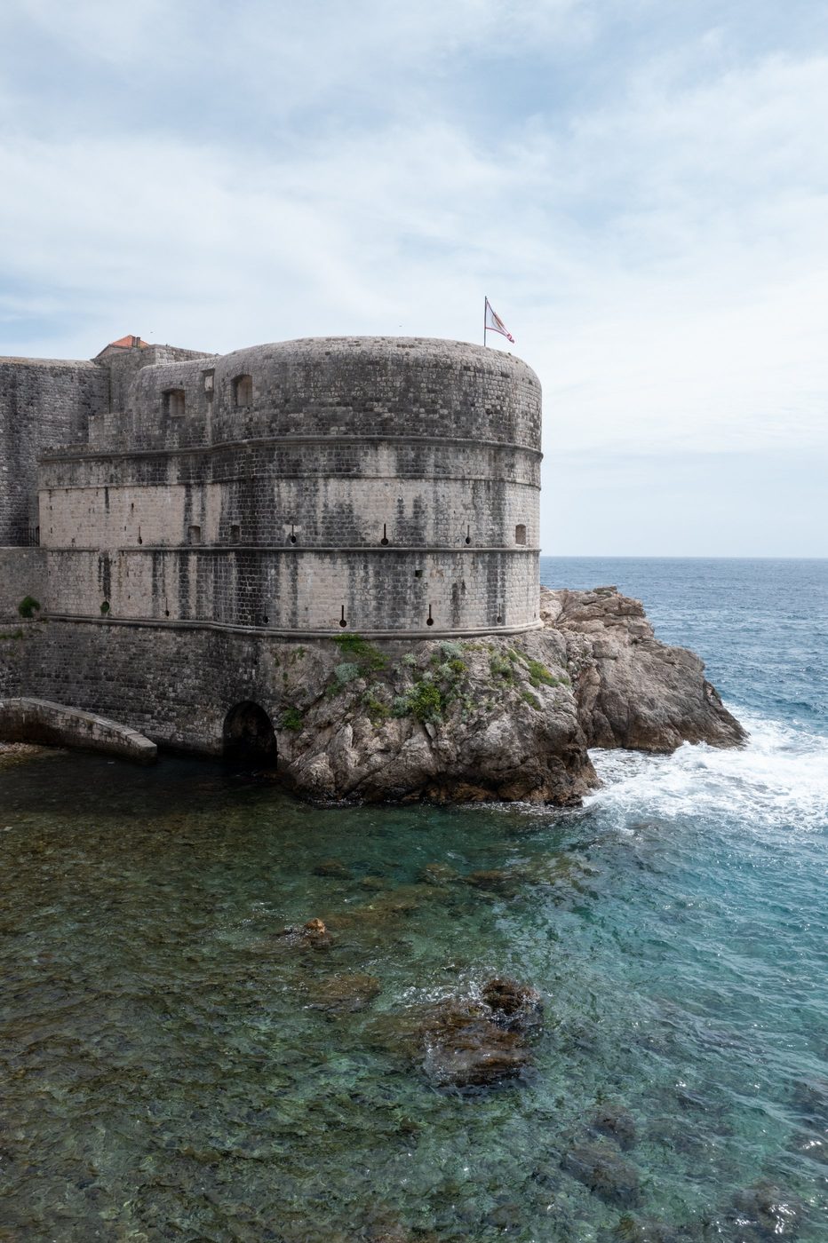 Round bastion of the fortress overlooking turquoise water, Dubrovnik
