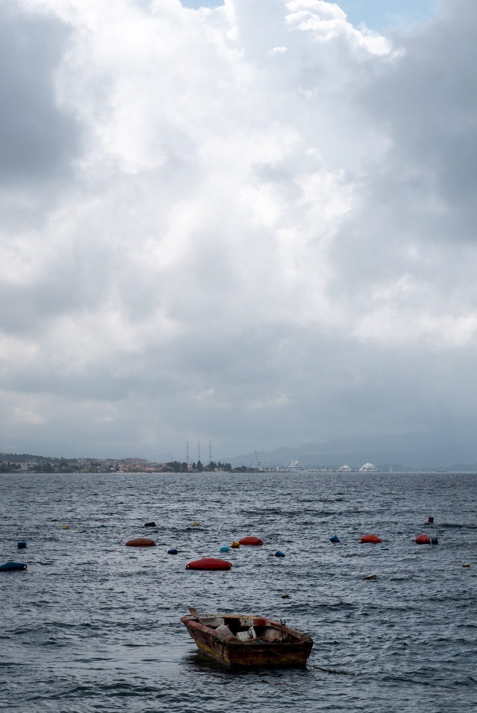 Small wooden boat isolated among buoys on a choppy sea, Dubrovnik