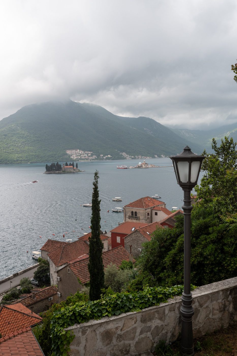 Streetlamp facing the monastery islets on the misty bay, Dubrovnik
