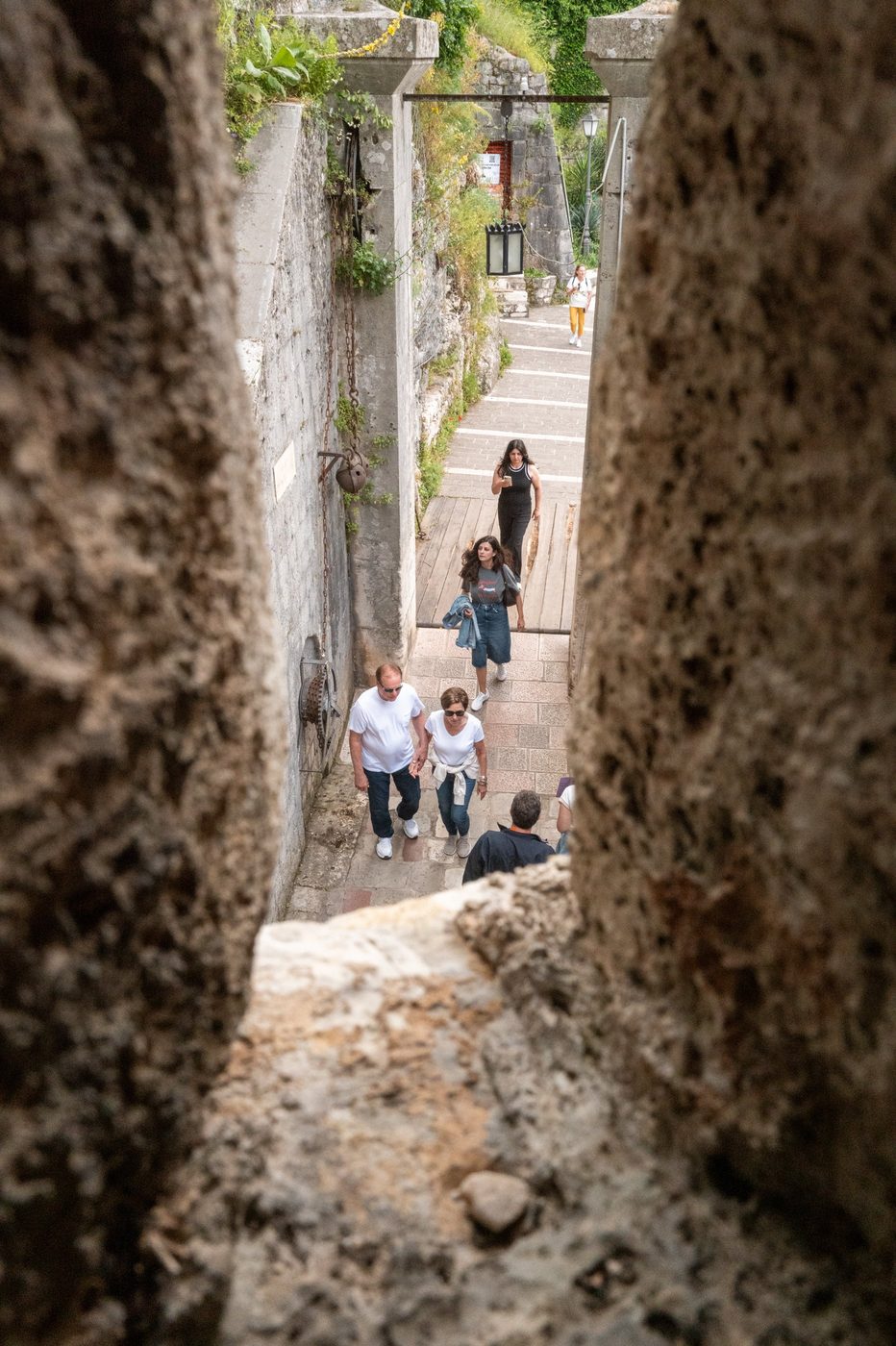 Group of tourists descending a staircase flanked by narrow ramparts, Dubrovnik