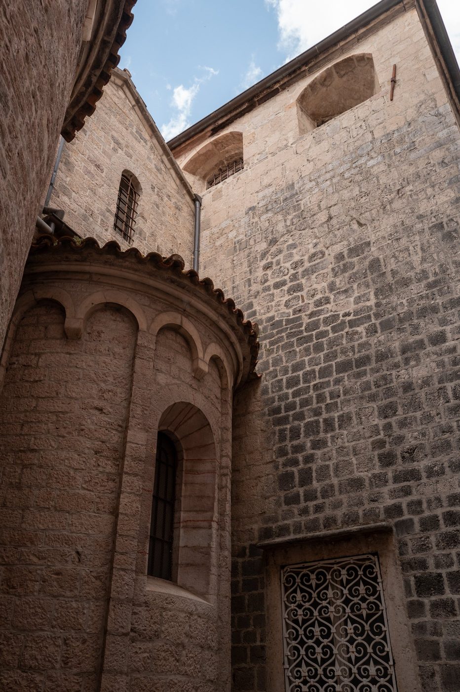Romanesque stone apse with arcading under a blue sky, Dubrovnik