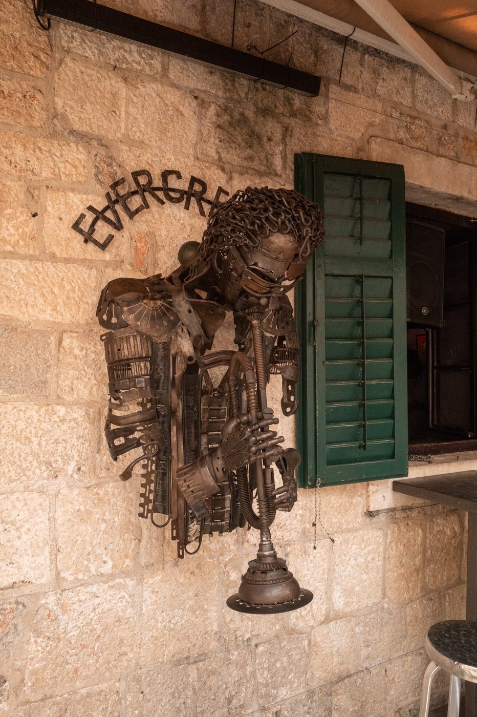 Recycled scrap-metal sculpture adorning a bar facade, Dubrovnik