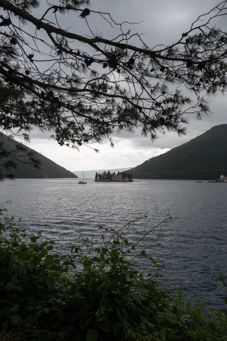 Solitary sailboat near the wooded islet in the middle of the bay, Dubrovnik