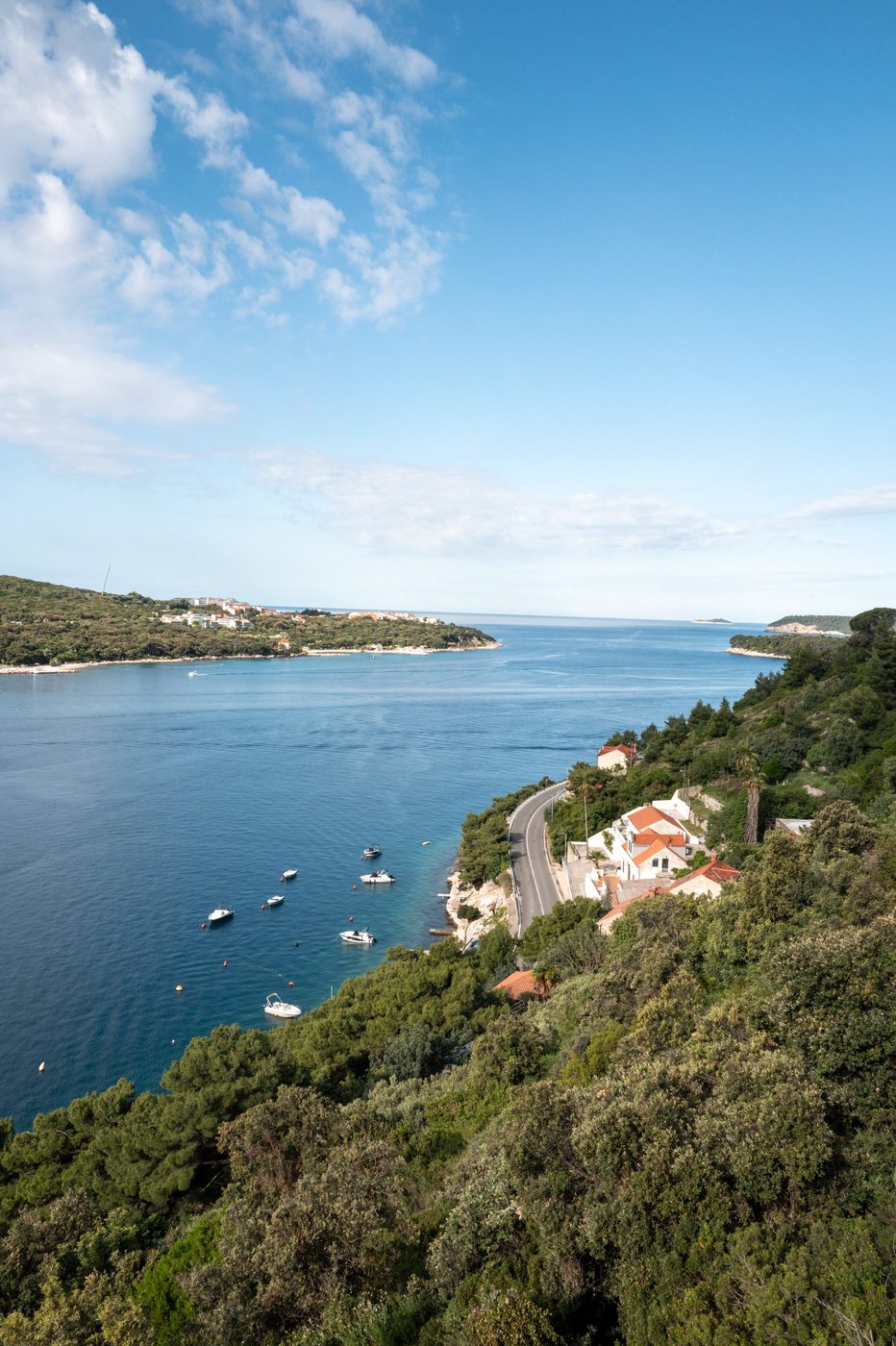 Winding road running along a cove dotted with small boats, Dubrovnik