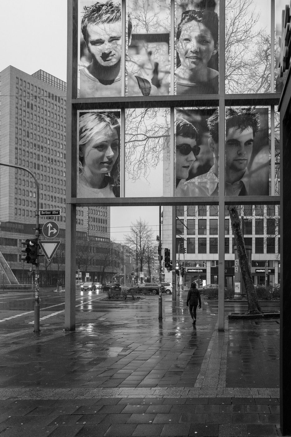 Giant portraits displayed on the glass facade of a building, Düsseldorf
