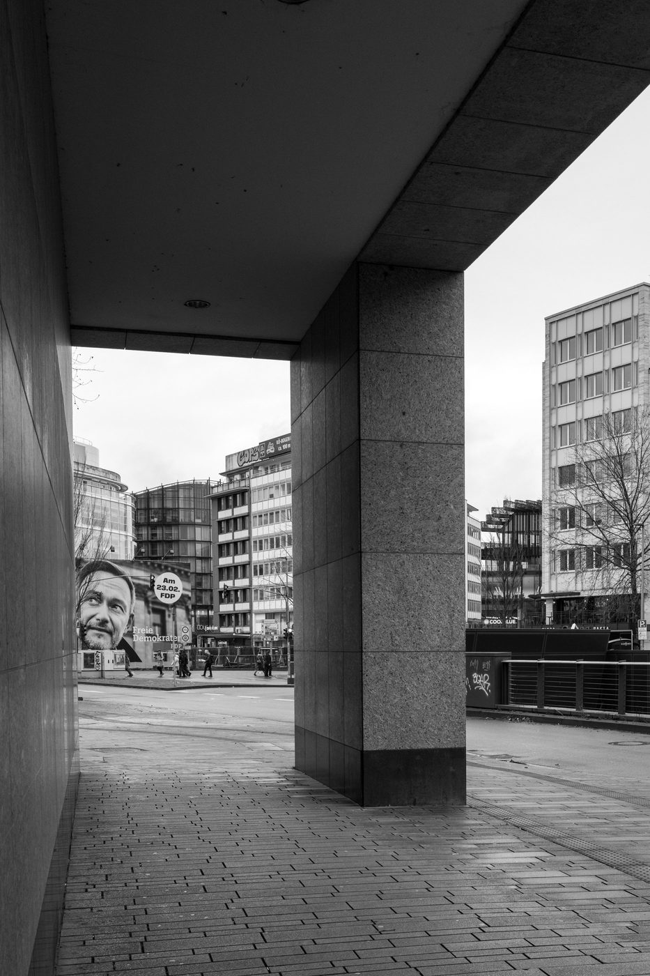 Giant election poster visible under a covered passage, Düsseldorf