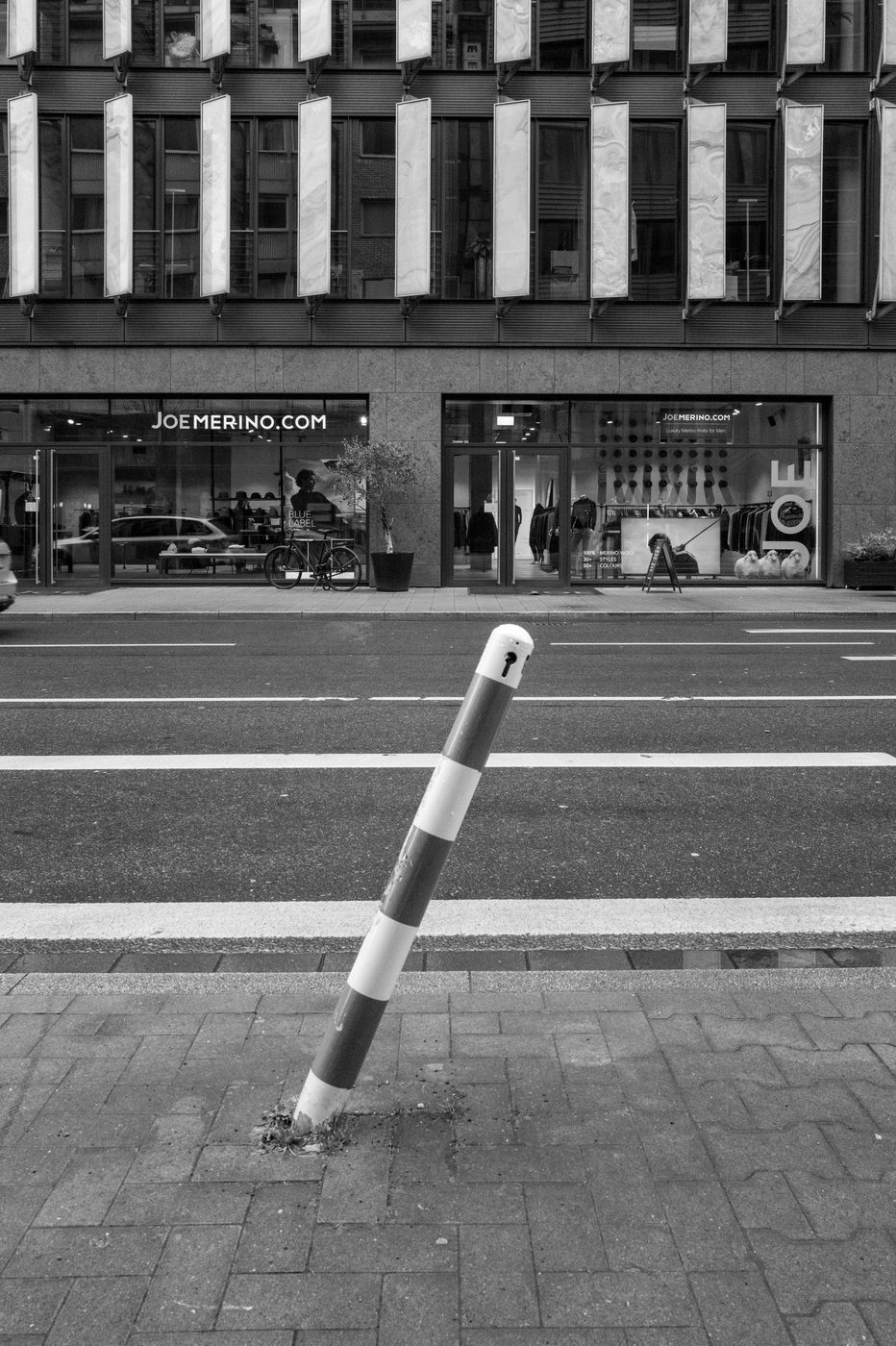 Leaning bollard in front of a men's fashion boutique, Düsseldorf
