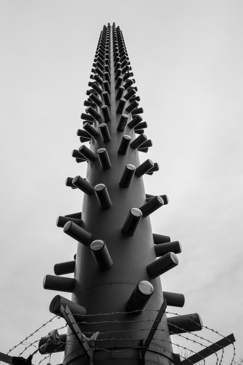 Metal sculpture bristling with spikes, seen from below against the sky, Düsseldorf