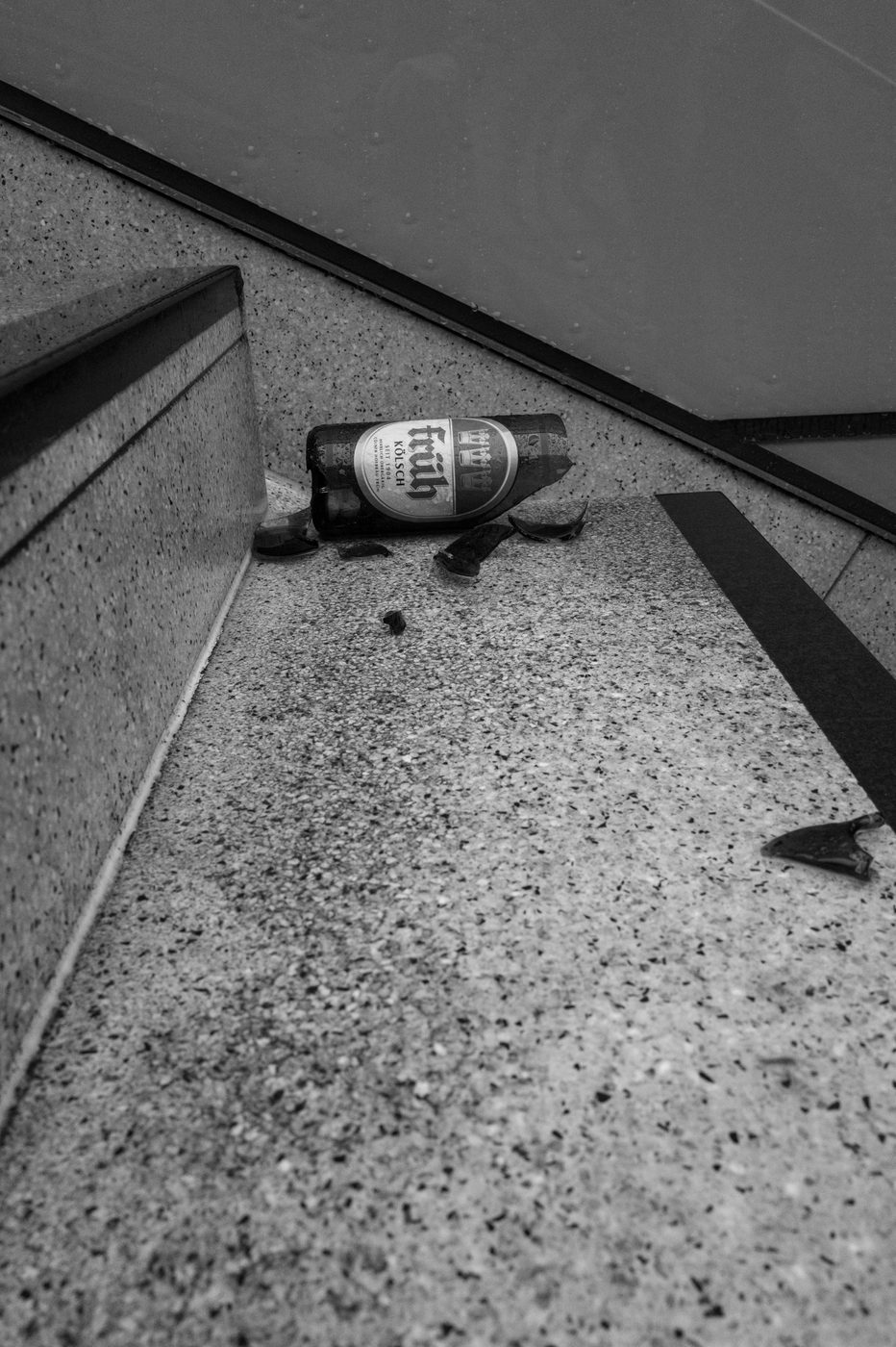 Broken beer bottle on the steps of a staircase, Düsseldorf
