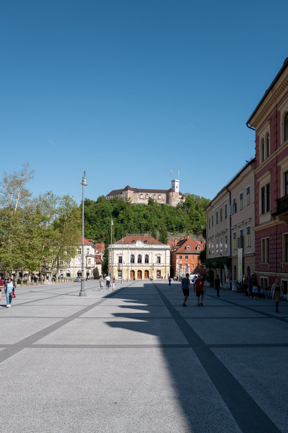 View across the square toward the castle perched on the hill, Ljubljana