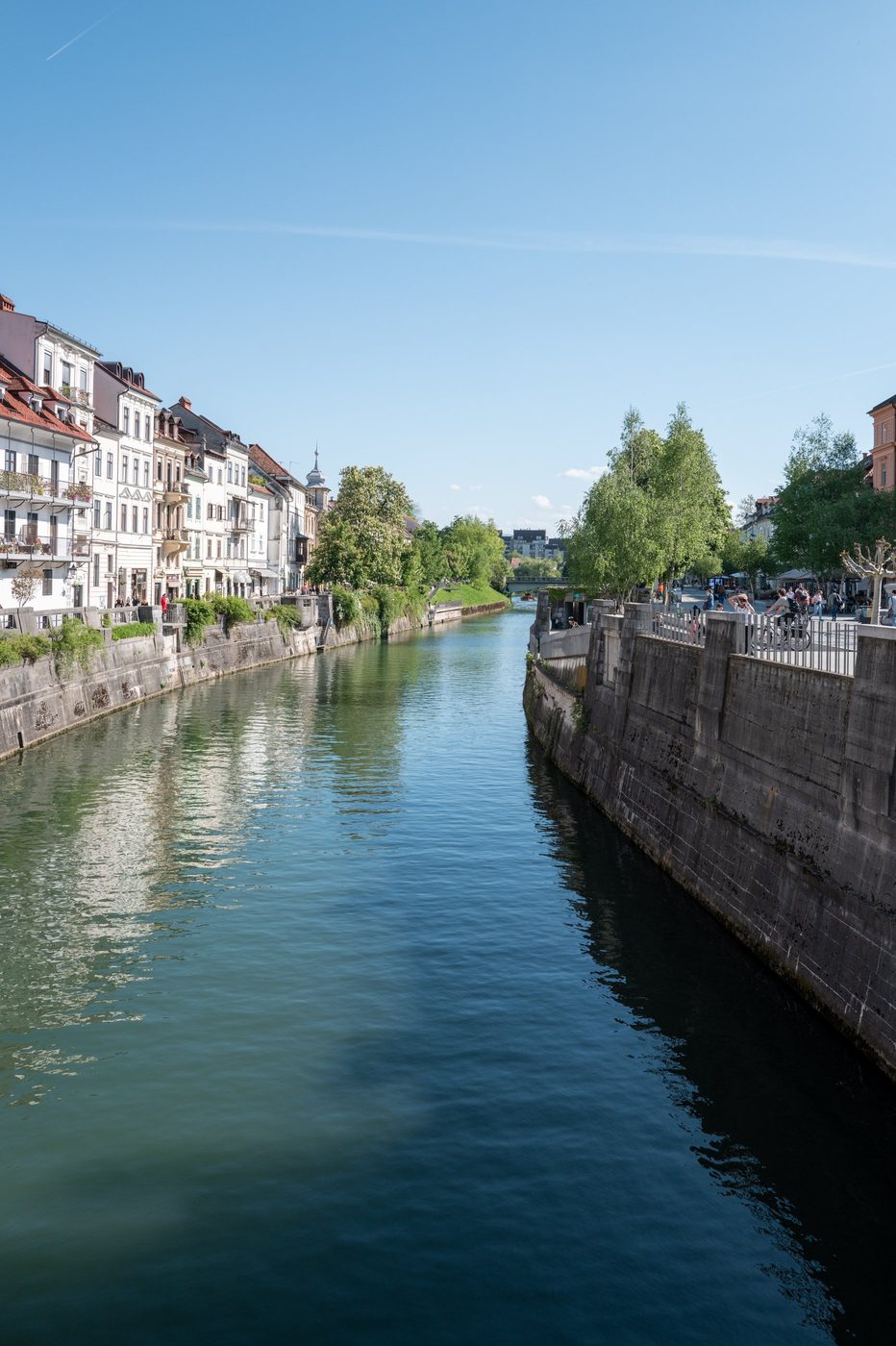 Reflections of old buildings in the calm waters of the Ljubljanica, Ljubljana