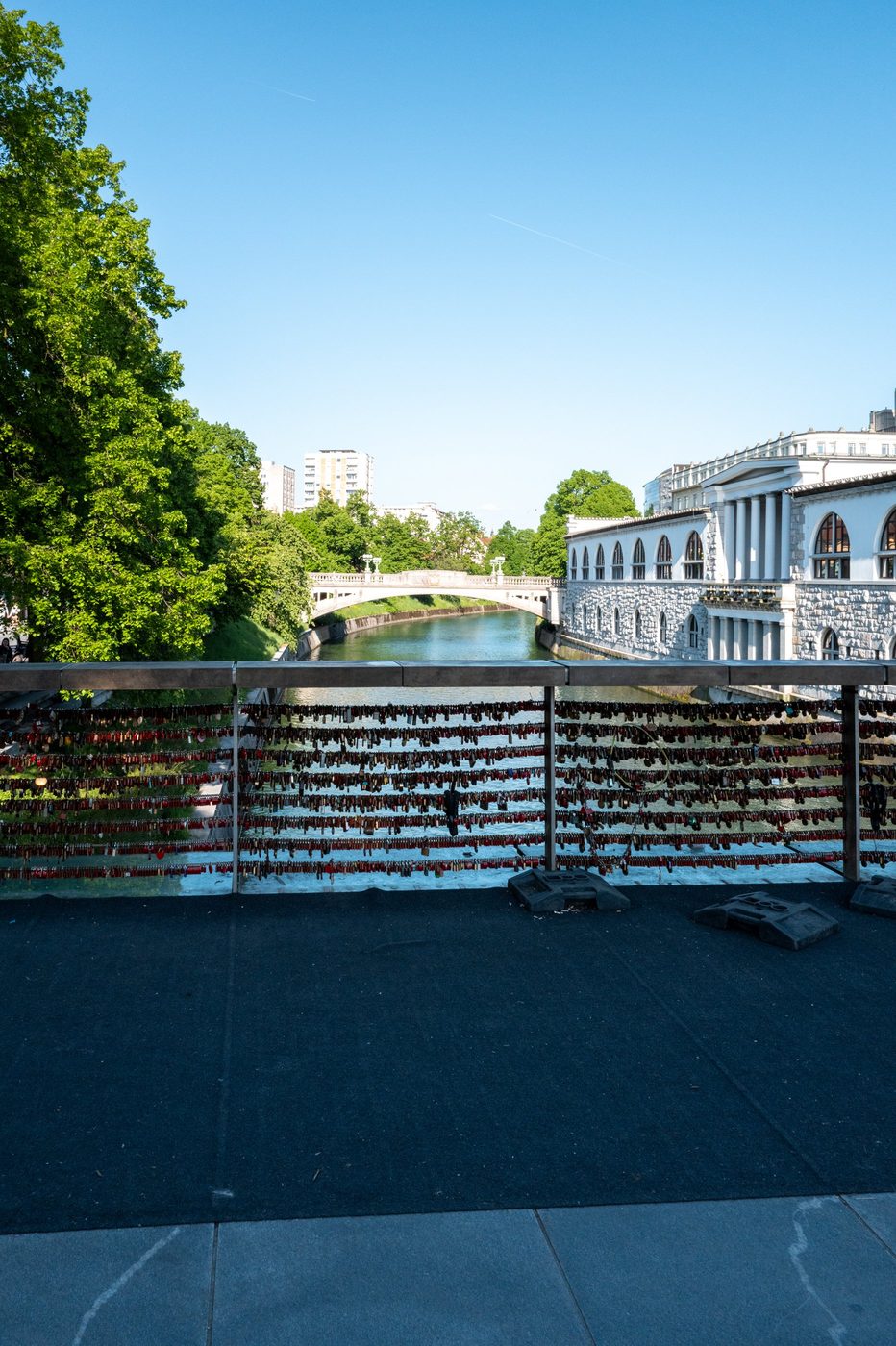 Lovers' padlocks attached to the bridge facing the white arcades, Ljubljana