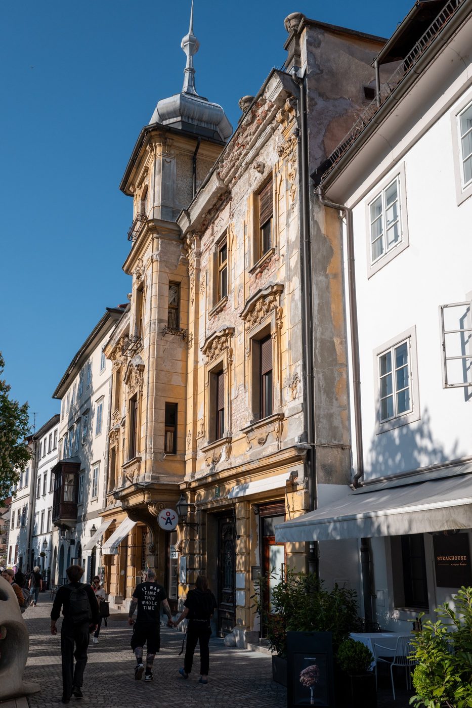 Baroque facade with a slender spire overlooking the old town, Ljubljana