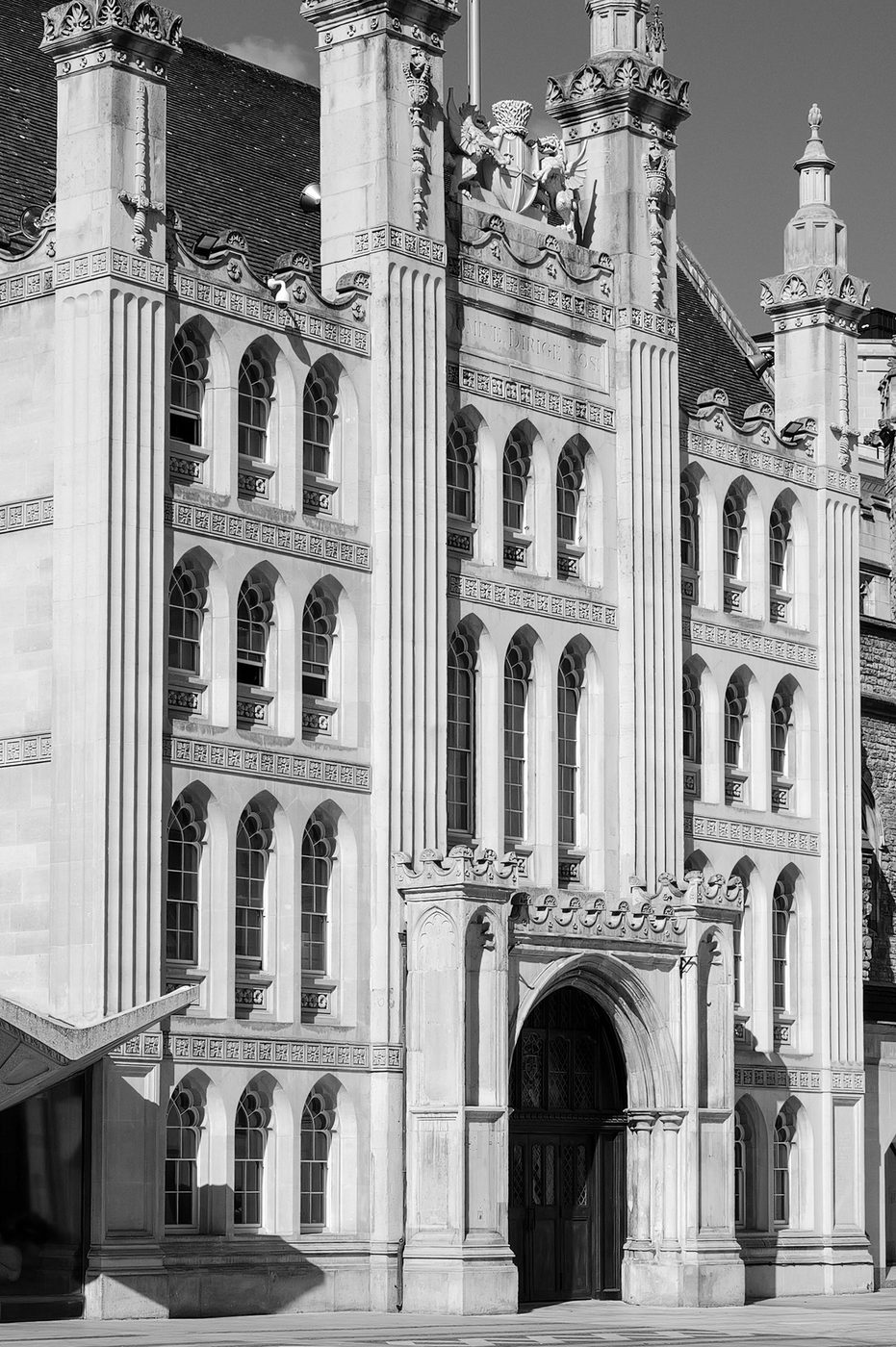 Neo-Gothic stone facade with the pointed-arch porch of the Guildhall, London