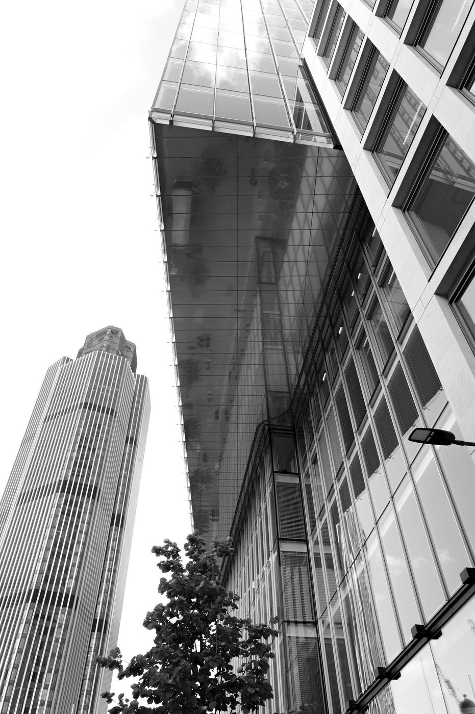 Low-angle view of two office towers with contrasting glass facades, London