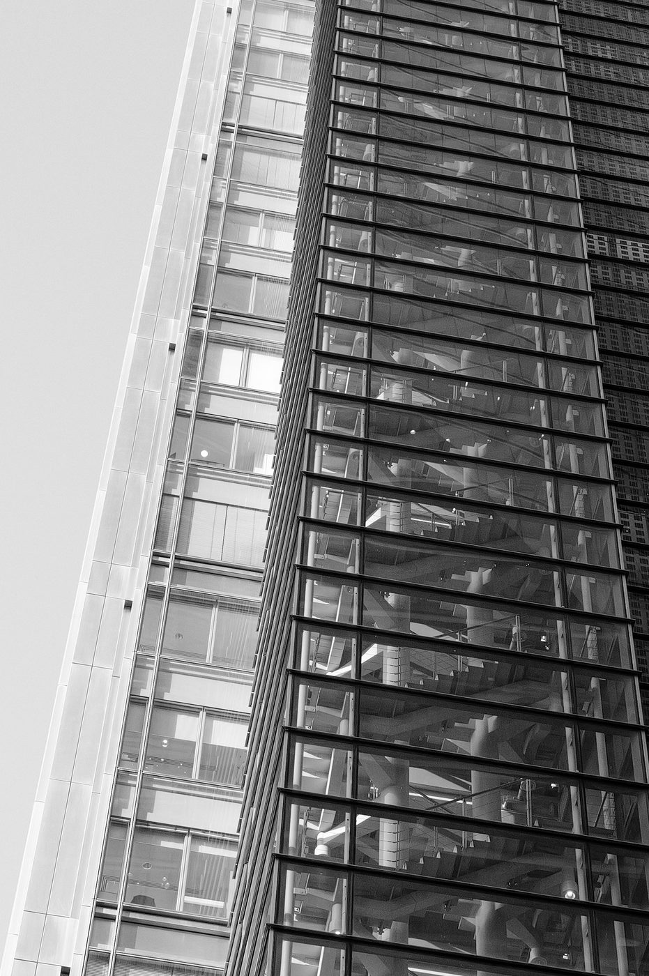 Graphic close-up of the diagonal lines of a skyscraper's glass facade, London