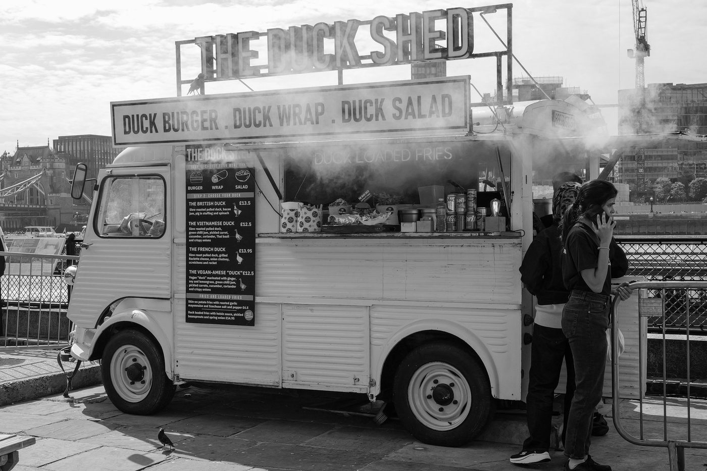 Vintage truck converted into a duck food truck, customers waiting for their order, London