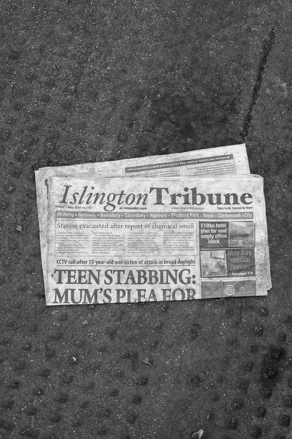 Local newspaper folded on the pavement, headline about a neighbourhood news story, London