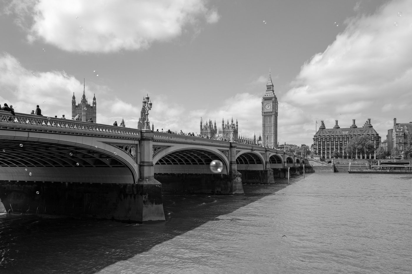 Westminster Bridge and Big Ben under a cloudy sky, soap bubbles floating in the air, London