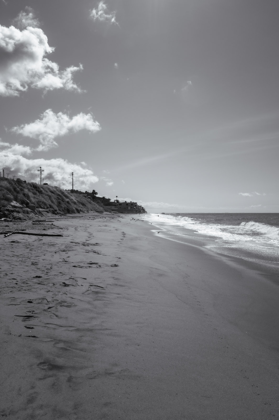 Sand dune facing the ocean under a cloudy sky, Los Angeles