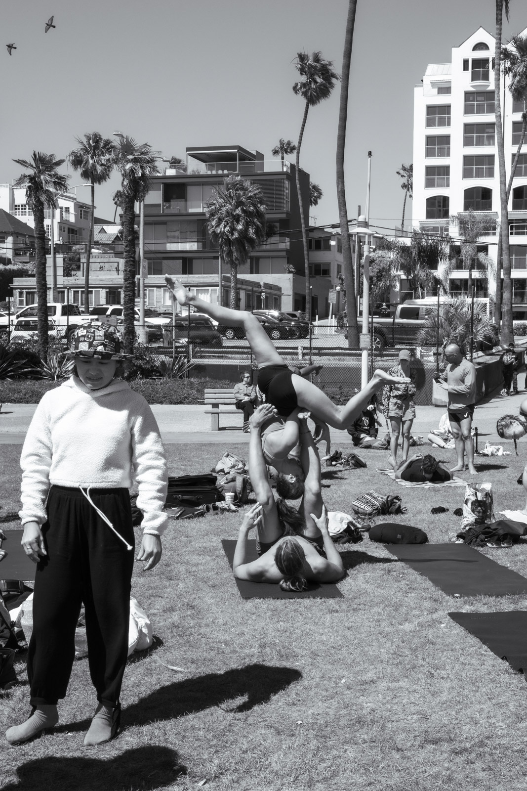 Two people stretching on the sand at the end of the day, Los Angeles