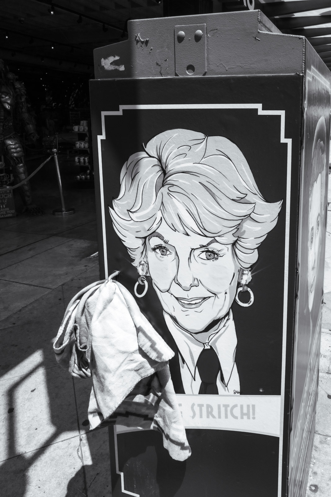 Illustrated poster stuck on a street pole, Los Angeles