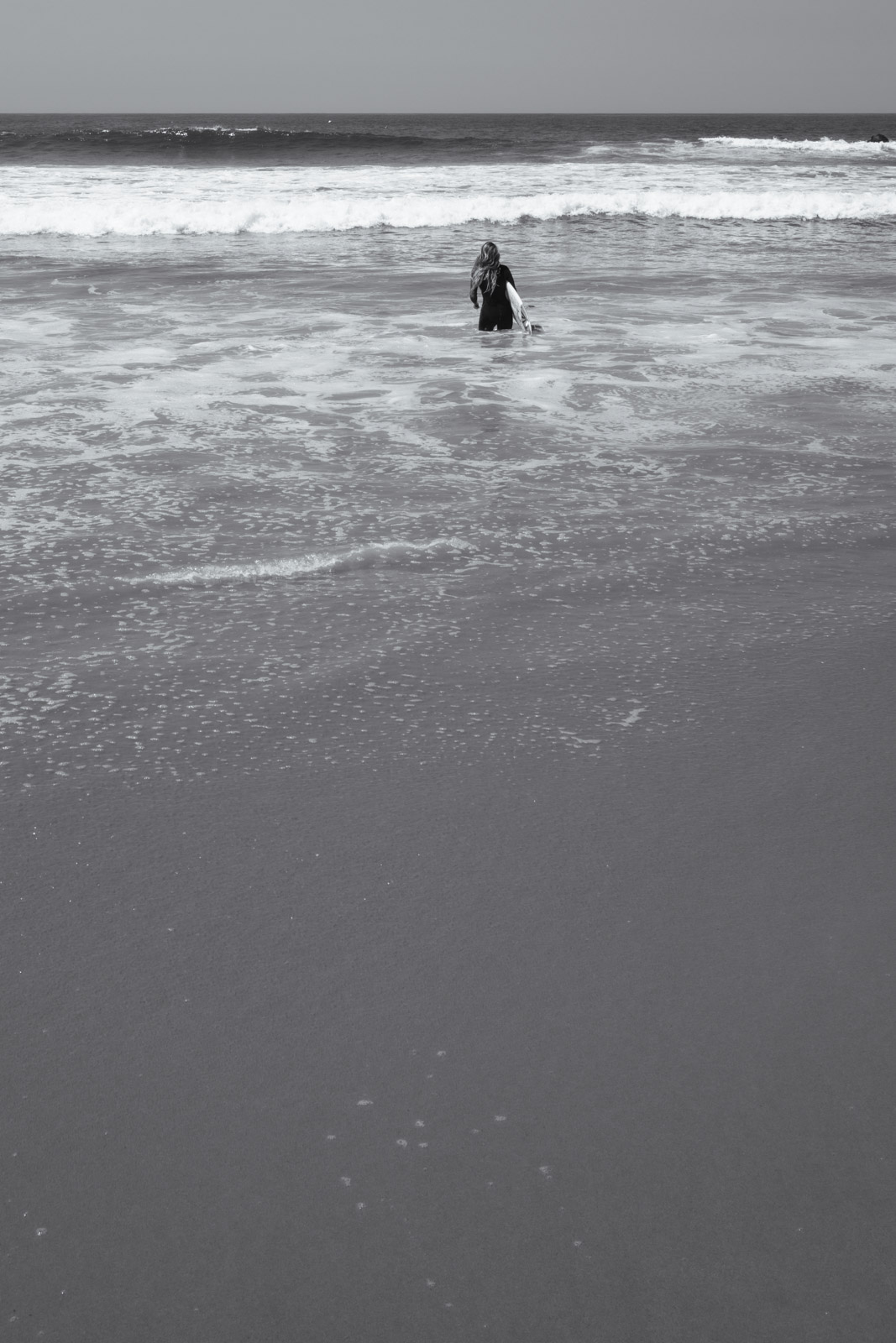 Solitary silhouette standing in the waves, Los Angeles