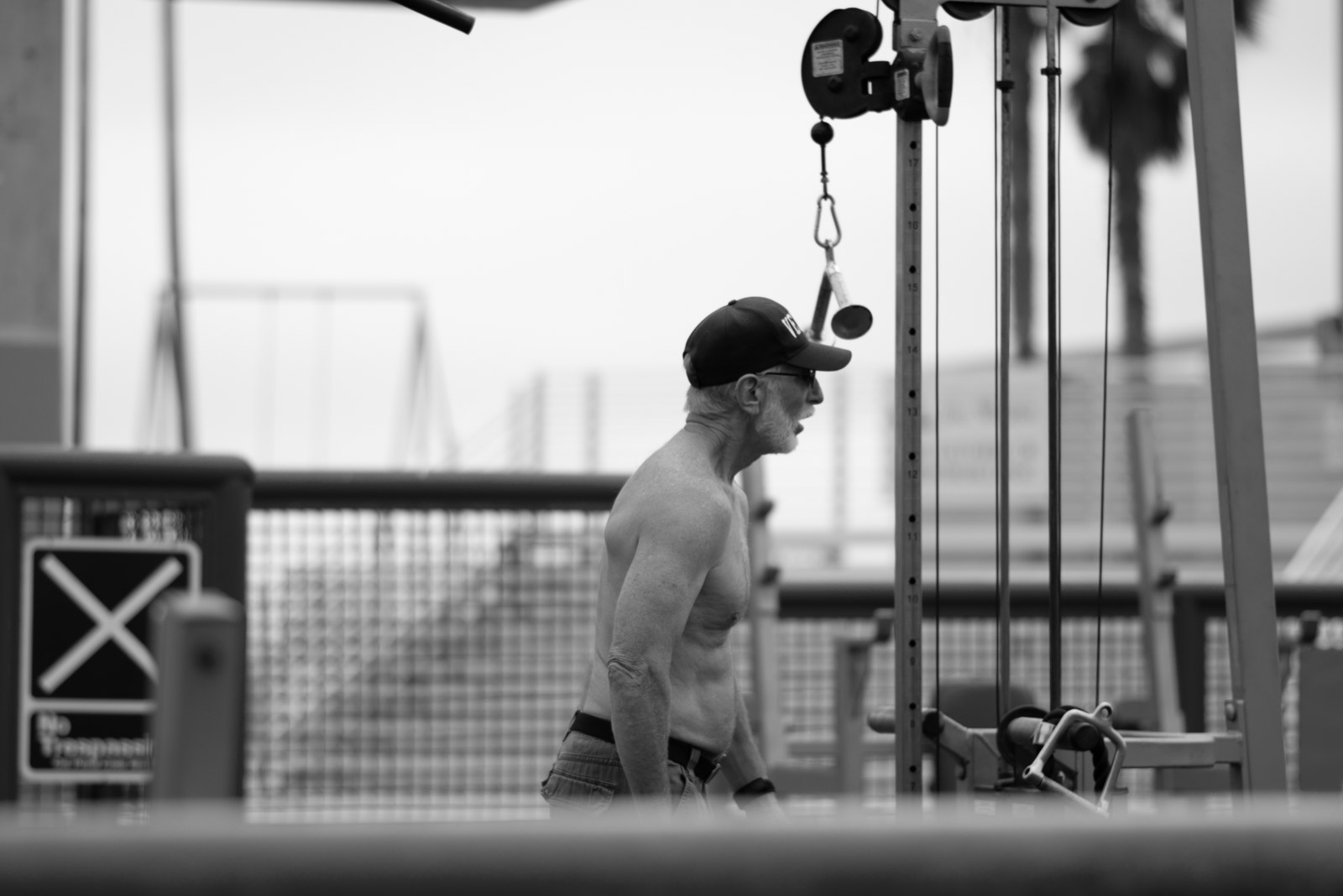 Man working out on outdoor pull-up bars, Los Angeles