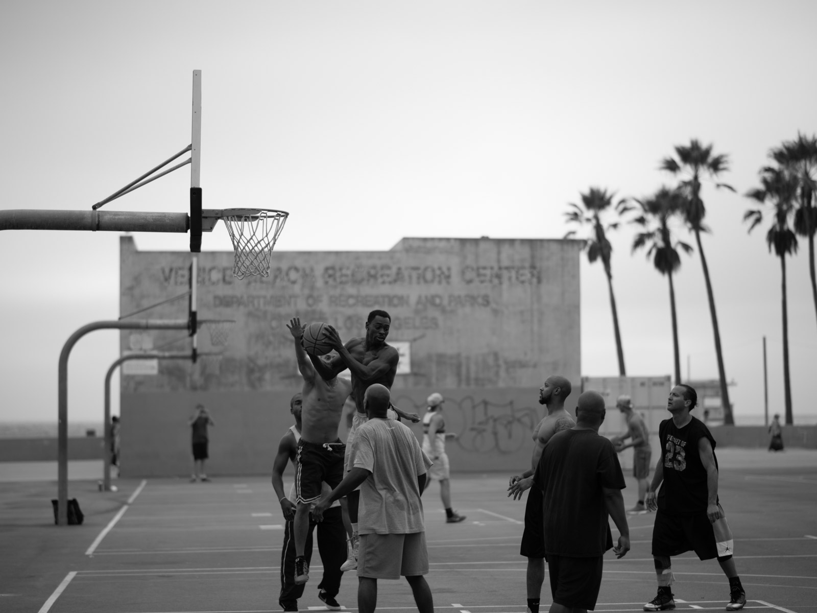 Pickup basketball game on an outdoor court, Los Angeles