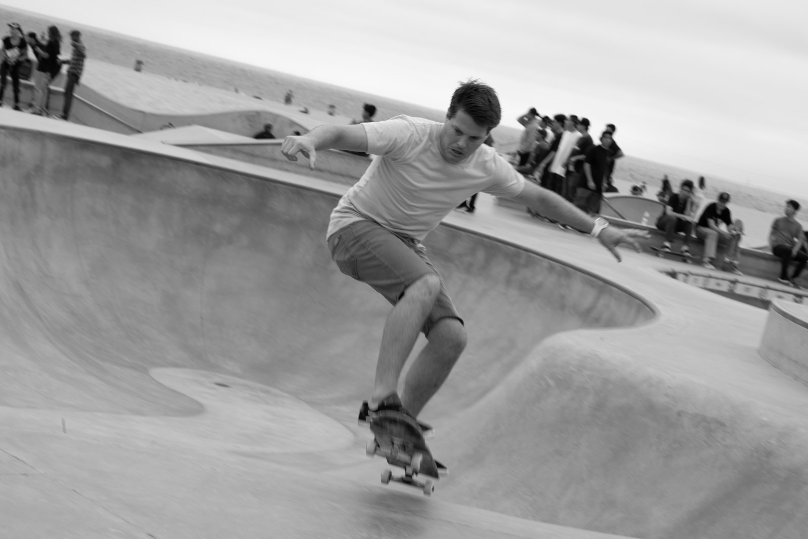 Skateboarder carving through a concrete bowl, Venice, Los Angeles