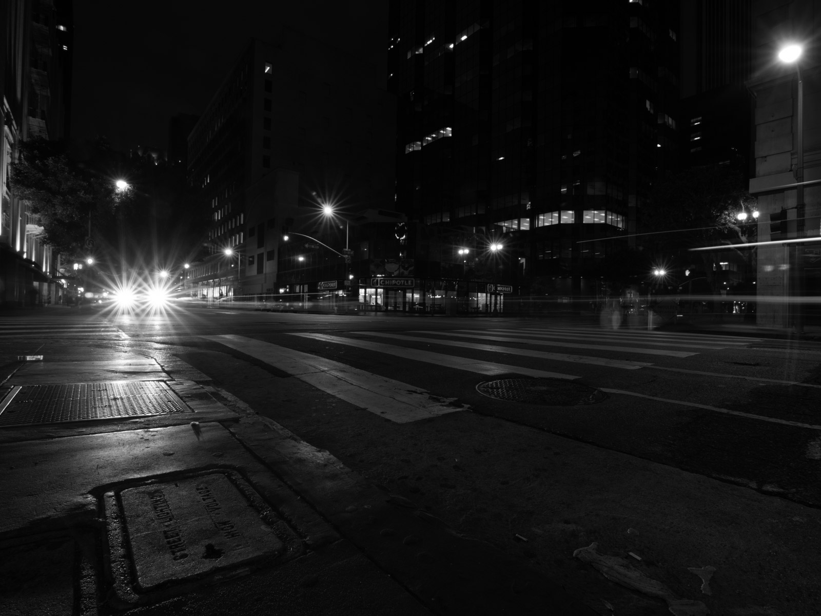Light trails from cars at a nighttime intersection, Los Angeles
