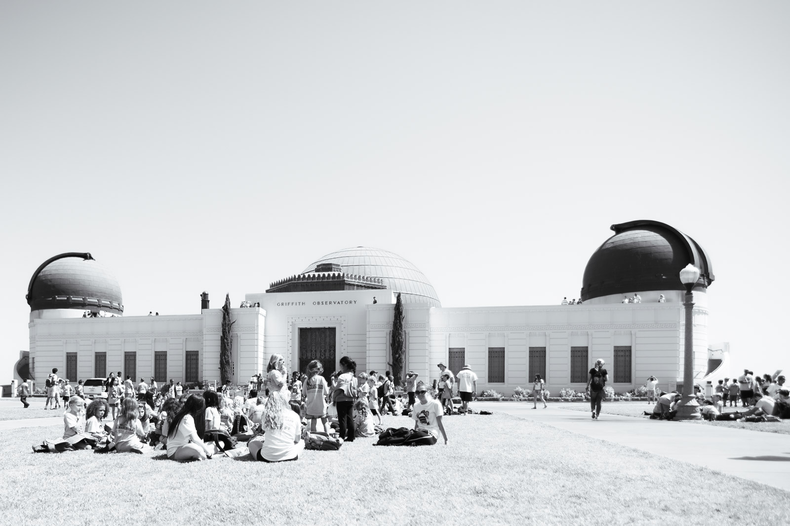 Crowd sitting on the lawn in front of the Griffith Observatory, Los Angeles