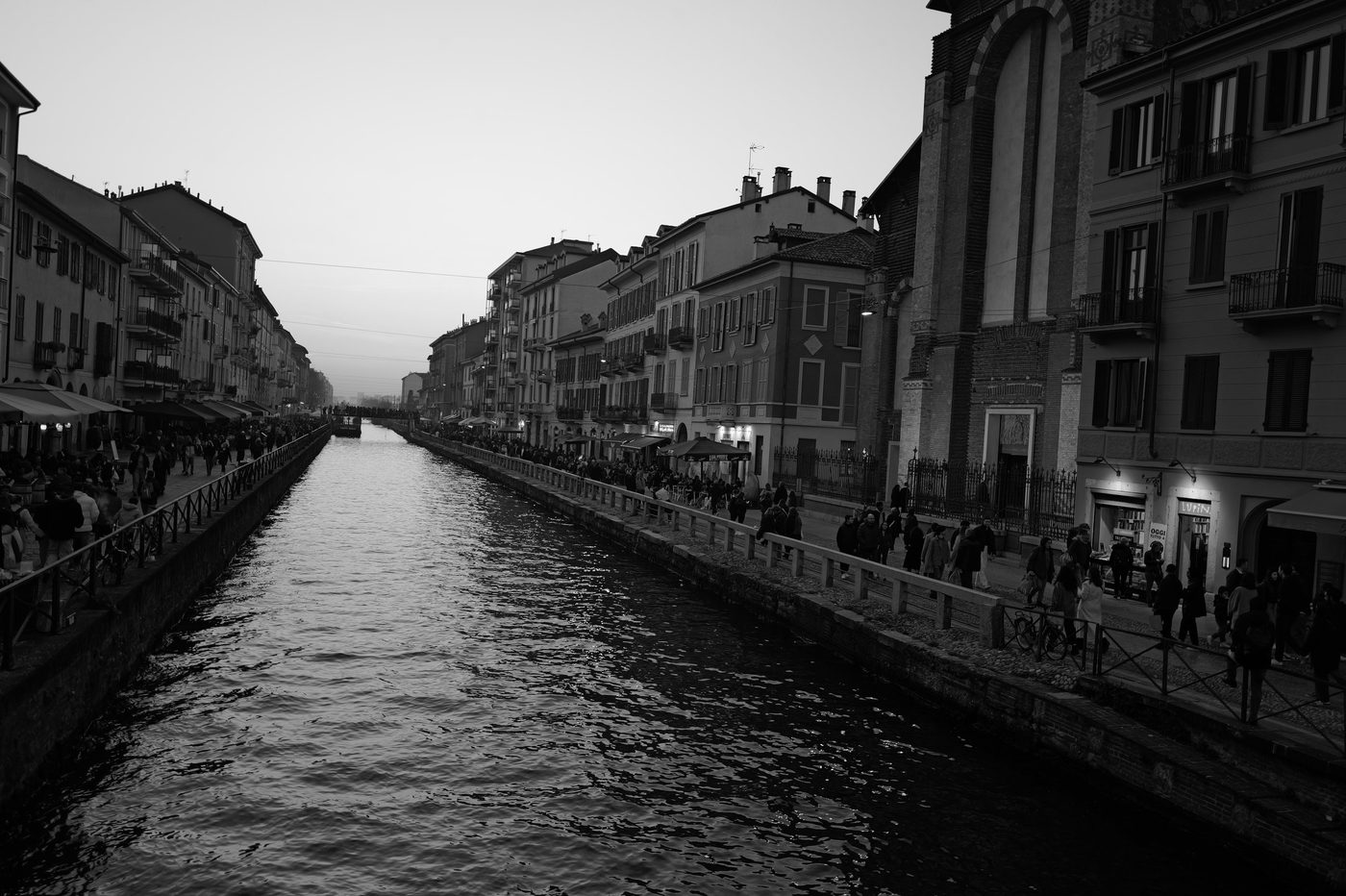 The lively Naviglio Grande at dusk, quaysides crowded with strollers, Milan