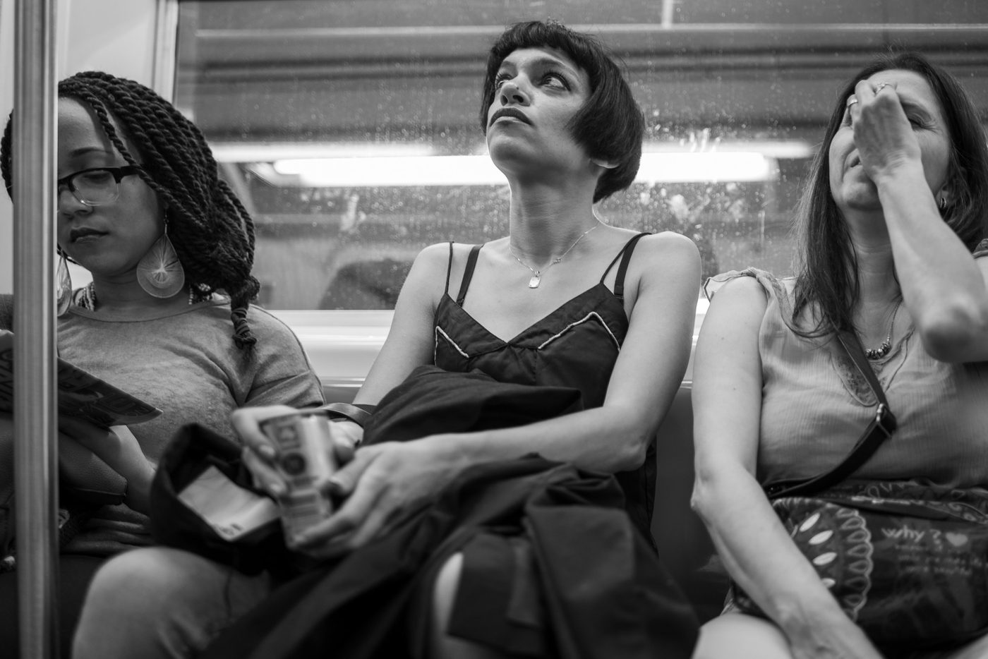 Three female subway passengers each lost in thought, New York