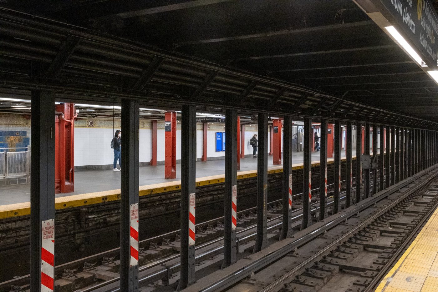Subway platform with red columns seen from the opposite track, New York