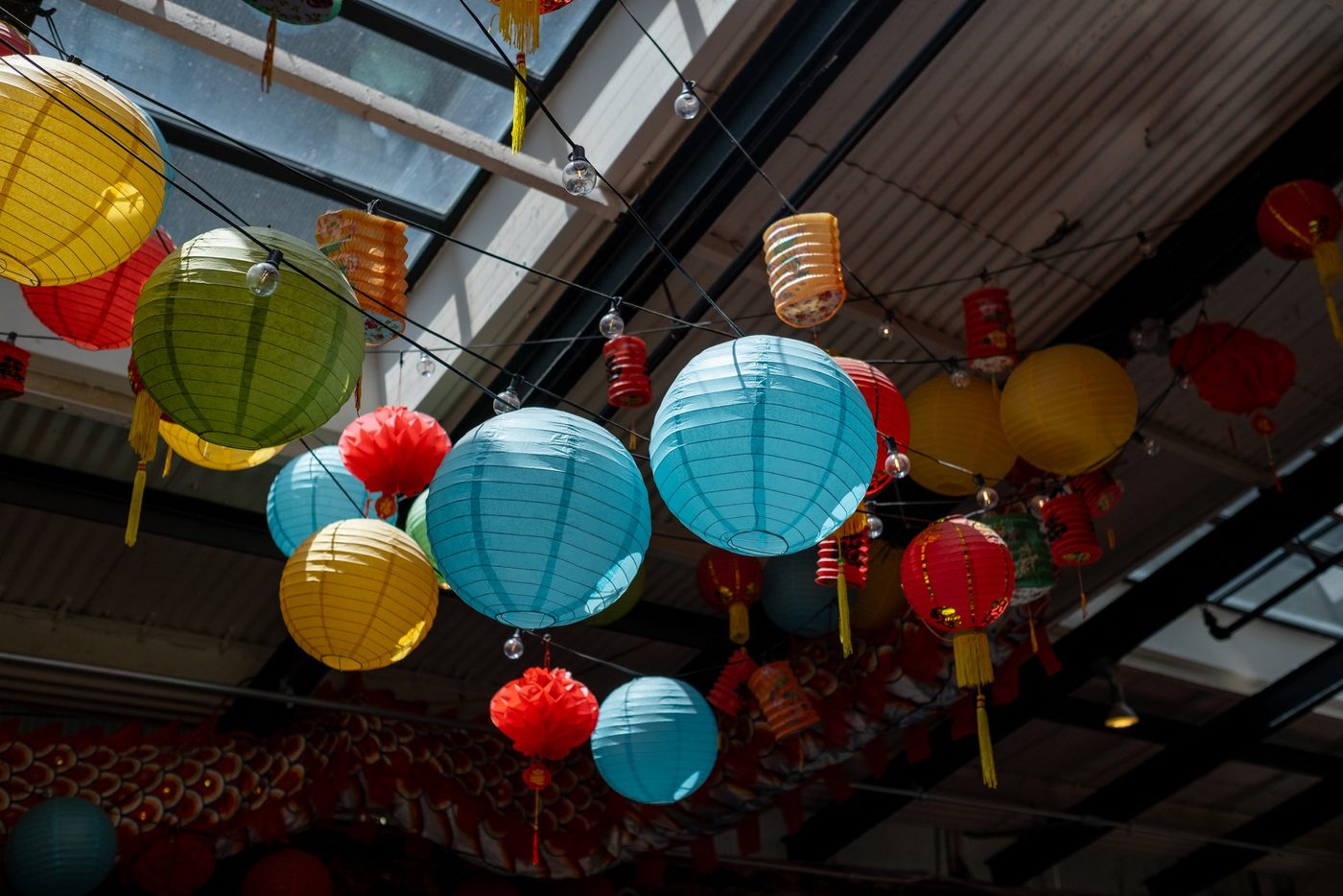 Multicolored lanterns hanging from the ceiling of a Chinatown street, New York