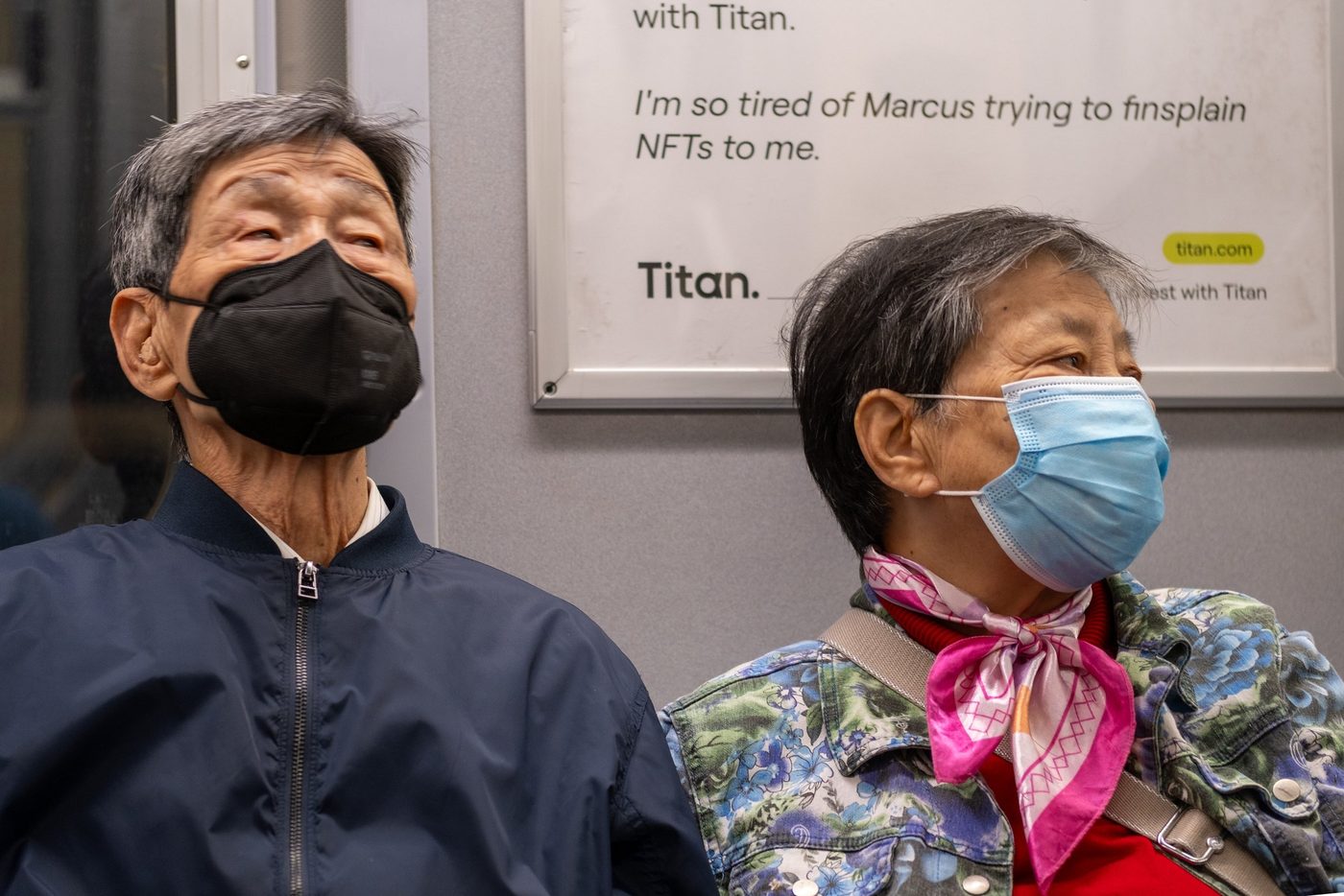 Masked elderly couple sitting side by side on the subway, New York