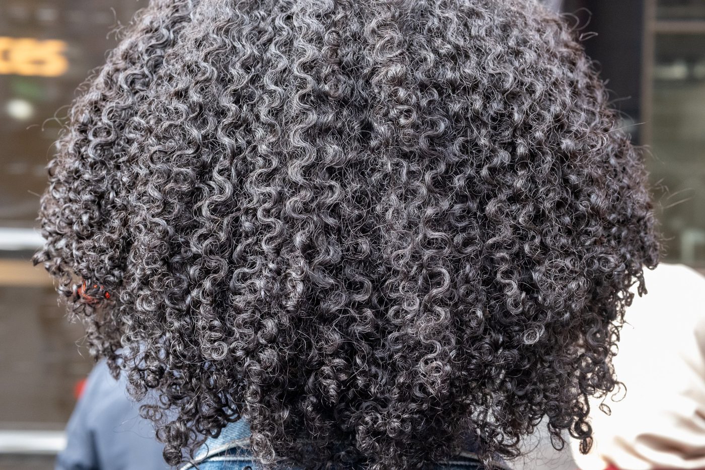 Close-up of salt-and-pepper curly hair, New York