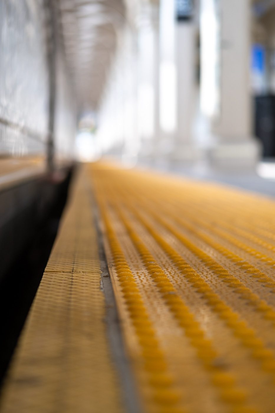 Close-up of the yellow non-slip strip at the platform edge, New York