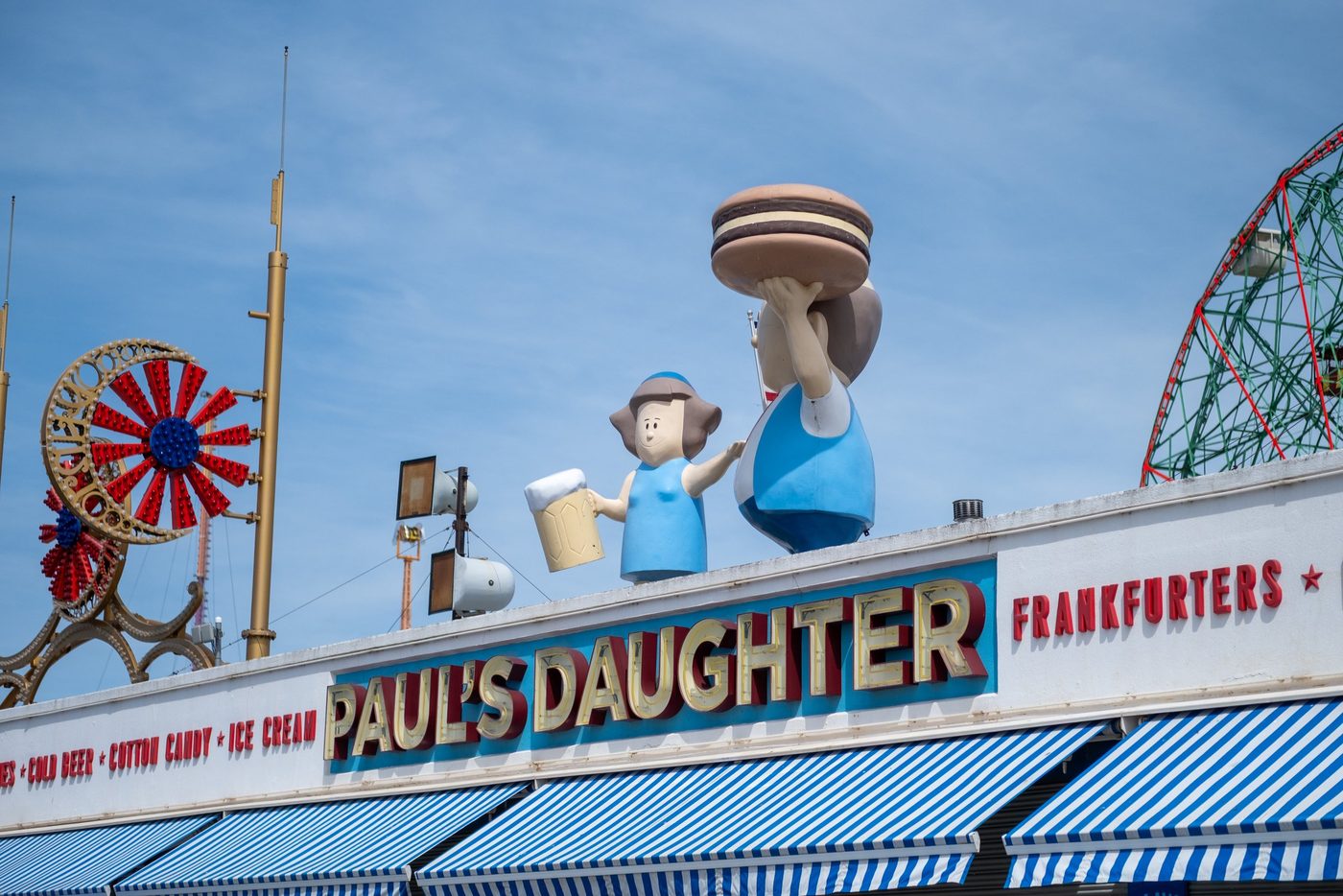 Giant statues atop the Paul's Daughter stand at Coney Island, New York