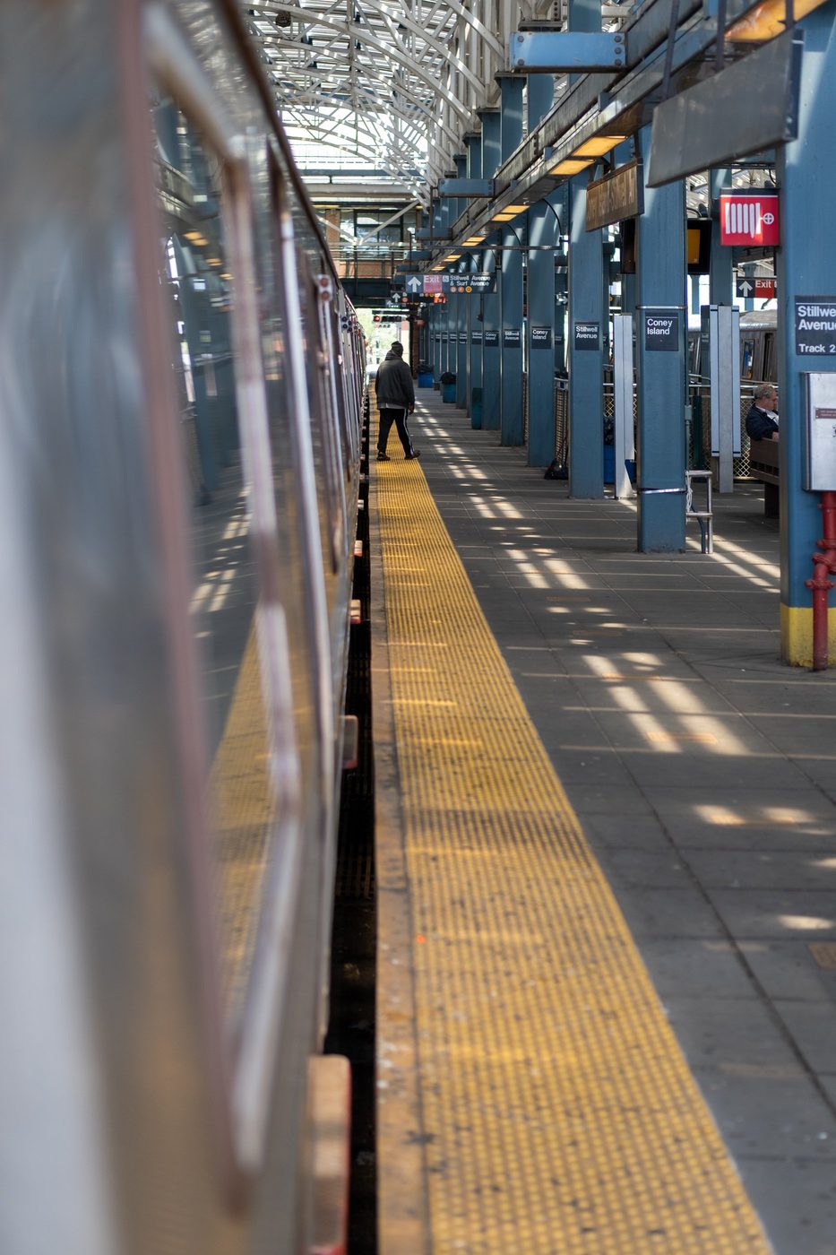 Man walking alone on the platform of Stillwell Avenue Coney Island station, New York